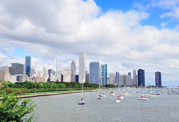 Chicago city downtown urban skyline with skyscrapers over Lake Michigan with cloudy blue sky.