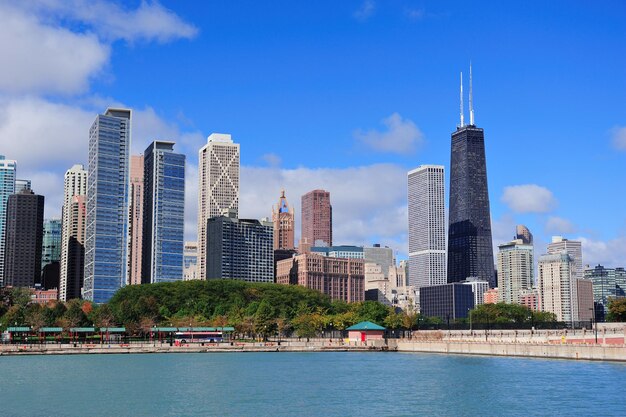 Chicago city urban skyline with skyscrapers over Lake Michigan with cloudy blue sky.