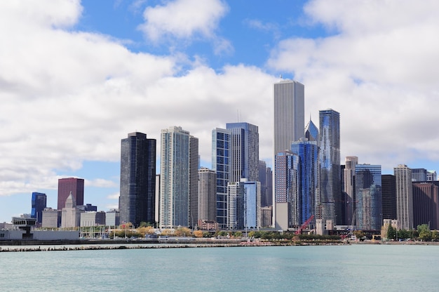 Chicago city urban skyline with skyscrapers over Lake Michigan with cloudy blue sky.