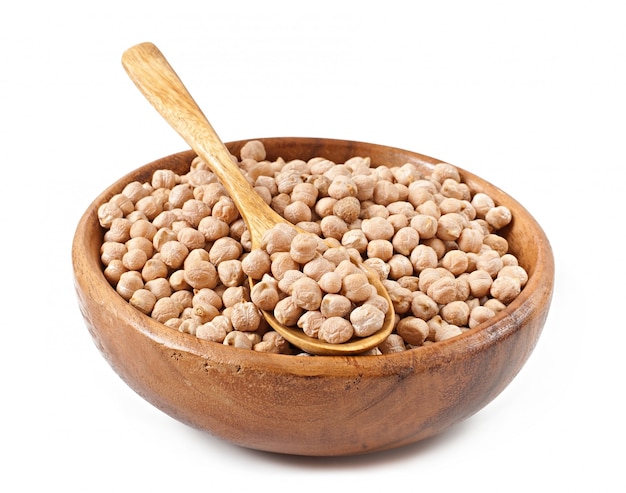 Chick-pea in wooden bowl on wooden surface