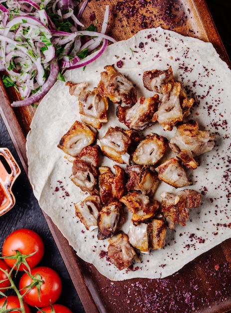 Chicken barbecue in lavash bread with salad and herbs.