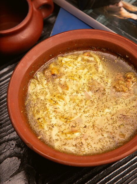닭고기 국수, 도자기 그릇에 호두와 스파게티 수프.