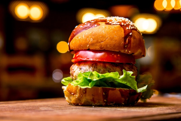 Chicken burger on wooden board side view