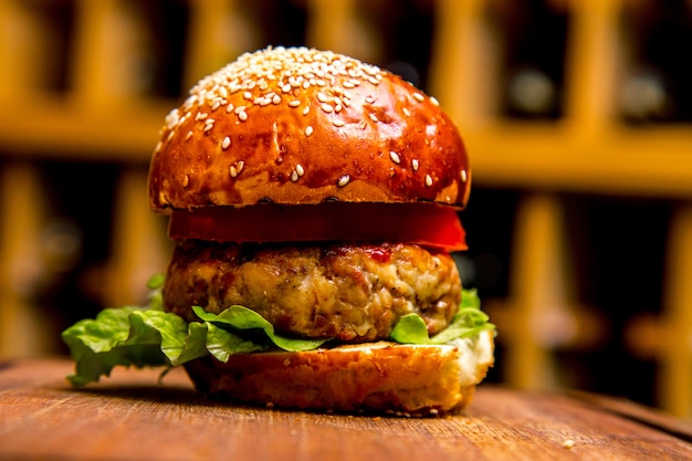 Free photo chicken burger on wooden board side view