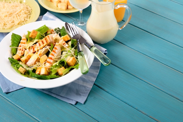 Chicken caesar salad on picnic table