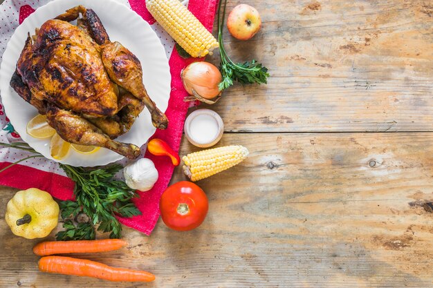 Chicken between different vegetables on tea cloth 