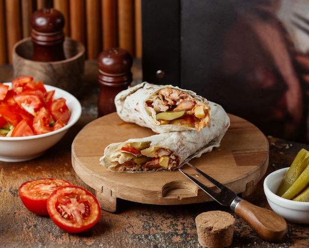 Chicken doner in lavash on wooden board