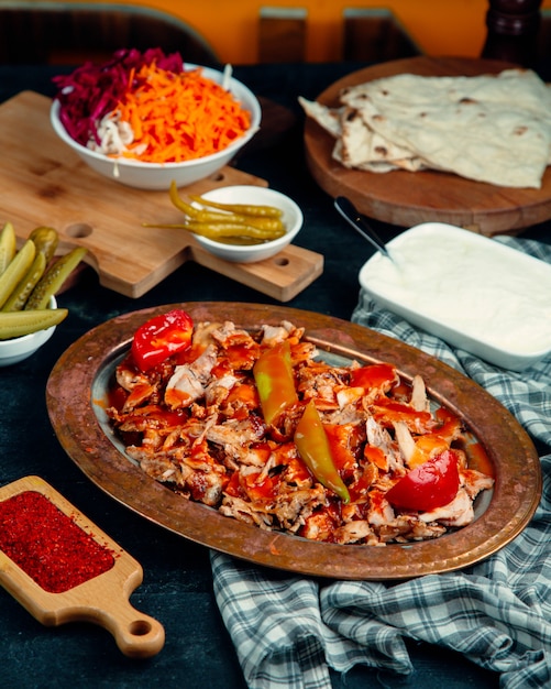 Chicken doner slices garnished with tomato sauce, pepper and fresh tomato