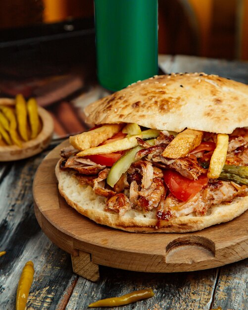 Chicken doner with tomato french fries and pickled cucumber