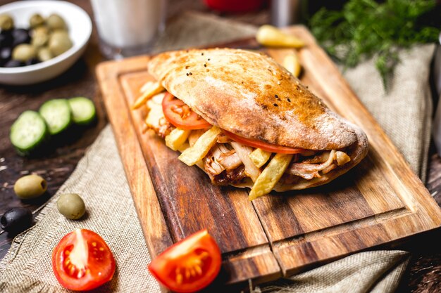 Chicken doner with tomato french fries and pickles
