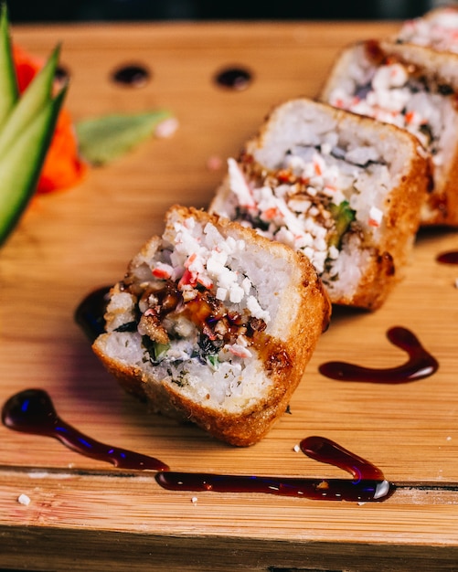 Chicken fillet rolls with stuffing and teriyaki sauce.