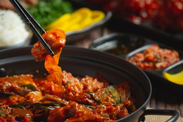 Chicken fried in hot pot with spicy sauce in korean style