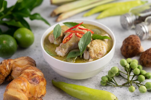 Chicken green curry in a bowl .