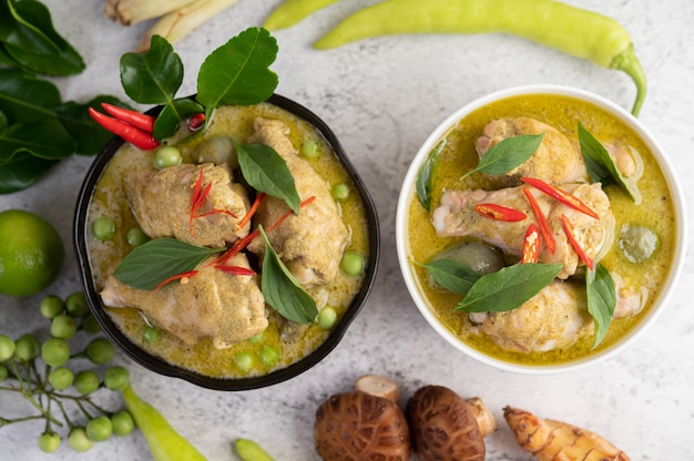 Chicken green curry in a bowl .