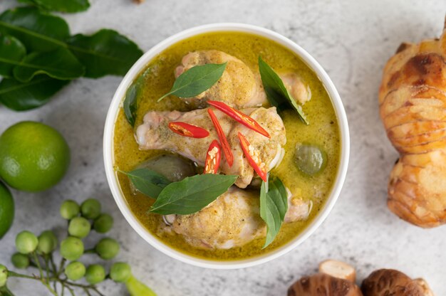 Chicken green curry in a bowl .