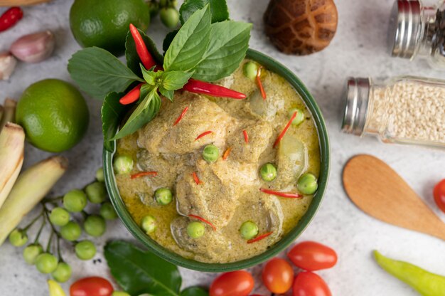 Chicken green curry in a bowl .