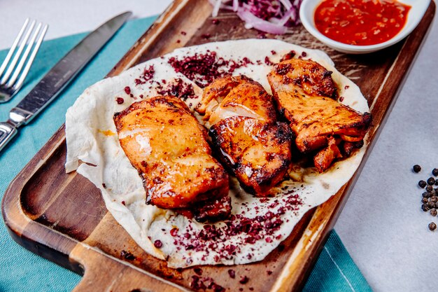 Chicken kebab on a wooden board