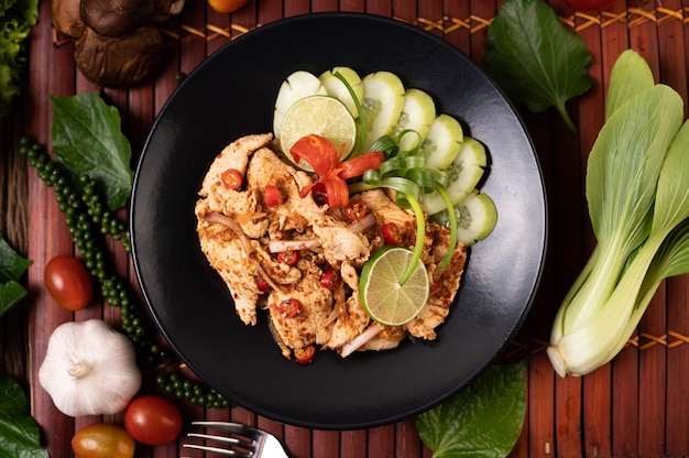 Chicken Larb on the plate With dried chilies, tomatoes, spring onions and lettuce