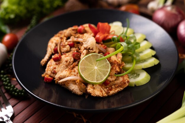 Chicken Larb on the plate With dried chilies, tomatoes, spring onions and lettuce