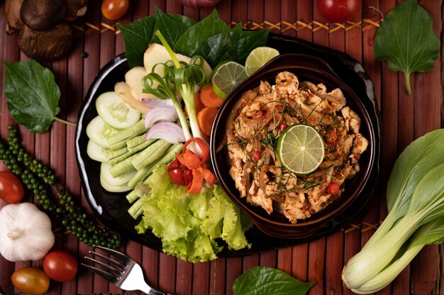 Chicken Larb on the plate With dried chilies, tomatoes, spring onions and lettuce