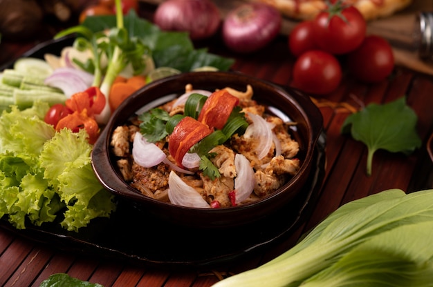 Chicken Larb on the plate With dried chilies, tomatoes, spring onions and lettuce