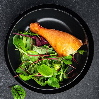 Chicken leg and salad leaves mix green healthy meal food snack on the table copy space food