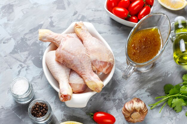 Chicken legs with spices and salt ready for cooking.