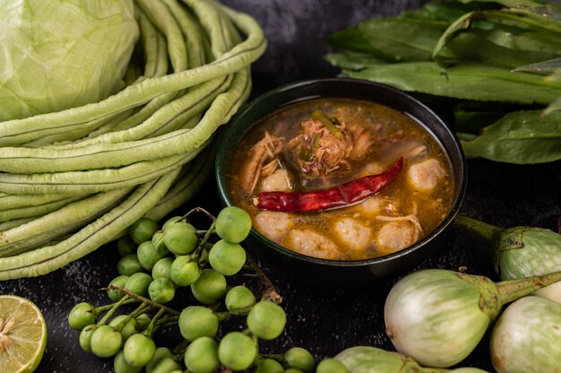 Chicken and meatball sauce with eggplant, chili, long beans, cabbage, and eggplant.