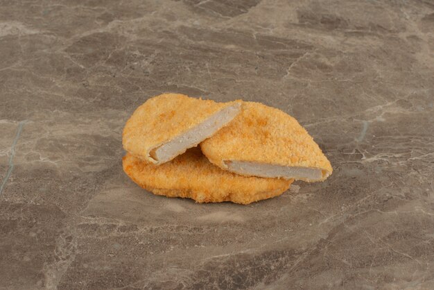 Chicken nuggets on marble surface.