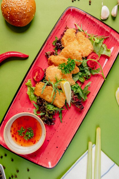 Chicken nuggets with herbs and sweet chili sauce