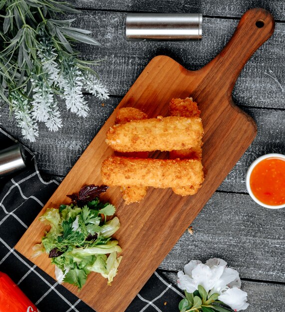 Chicken nuggets on wooden board