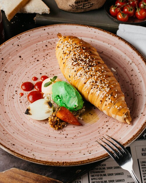 chicken in pastry with sesame seeds mustard ketchup and mayo on plate