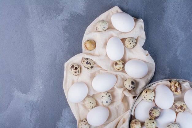 Chicken and quail eggs on the ground