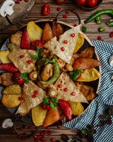 chicken saj with potato, aubergine, red bell pepper, flatbread pieces