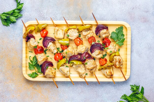 Chicken shish kebab with vegetables,ketchup,mayonnaise,top view