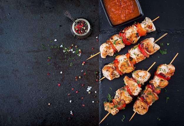 Chicken skewers with slices of sweet peppers and dill. Tasty food. Weekend meal. Top view. Flat lay.