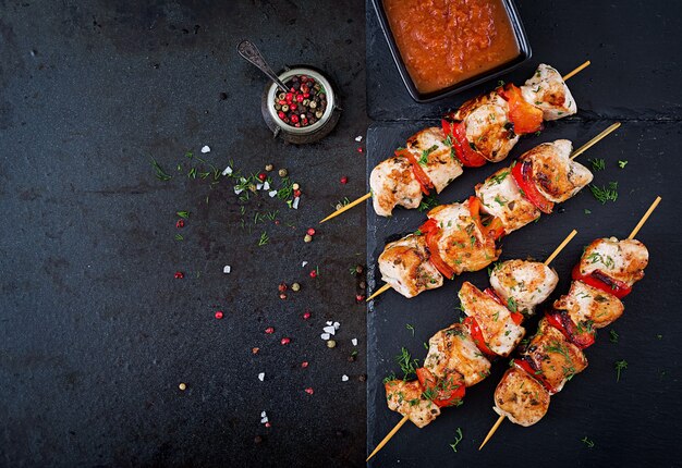 Chicken skewers with slices of sweet peppers and dill. Tasty food. Weekend meal. Top view. Flat lay.