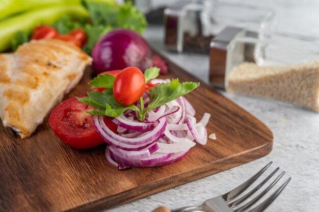 Chicken steak placed on a wooden tray.