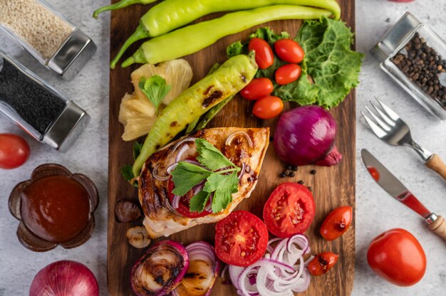 Chicken steak placed on a wooden tray.