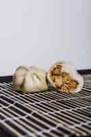 Free photo chicken stuffed dumpling on placemat against white backdrop