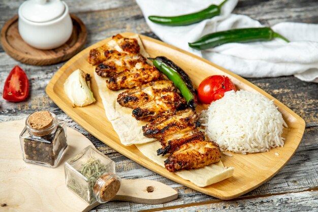 Chicken wings kebab  with rice  side view