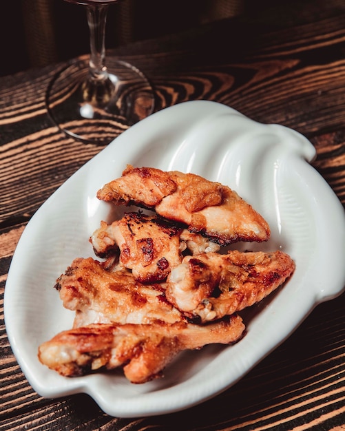 Chicken wings in a sauce in a white bowl