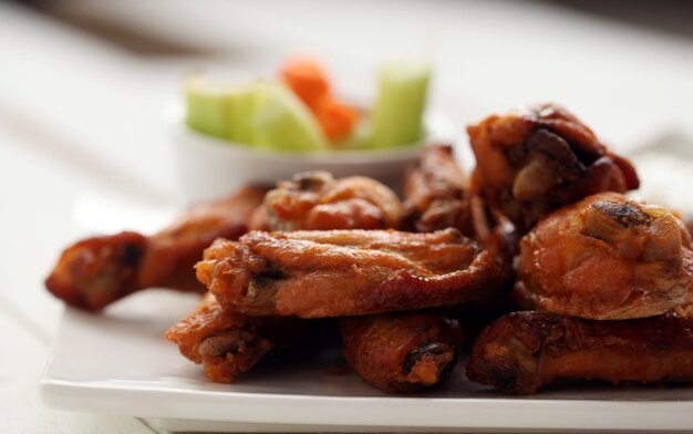 Chicken wings with sauce and vegetables 