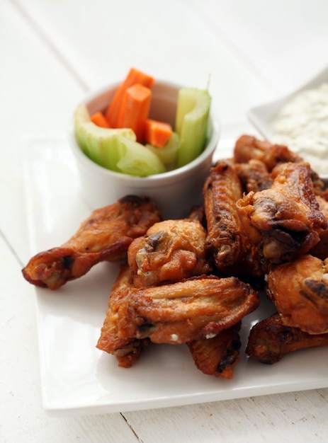 Chicken wings with sauce and vegetables 