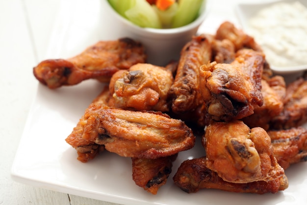 Chicken wings with sauce and vegetables 