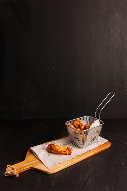 Chicken wings on wooden board