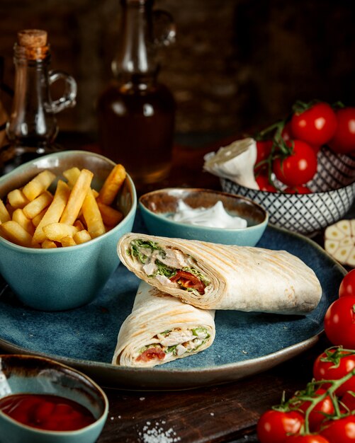 Chicken wrap and fries and tomato