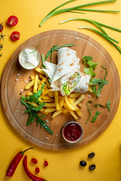 Chicken wrap with side fries and herbs