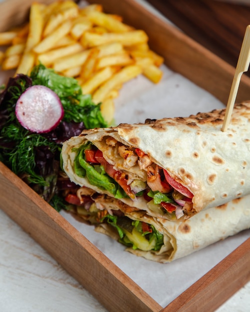 chicken wrap with vegetables and french fries
