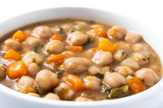 Chickpeas soup with vegetables in bowl isolated on white background Close up